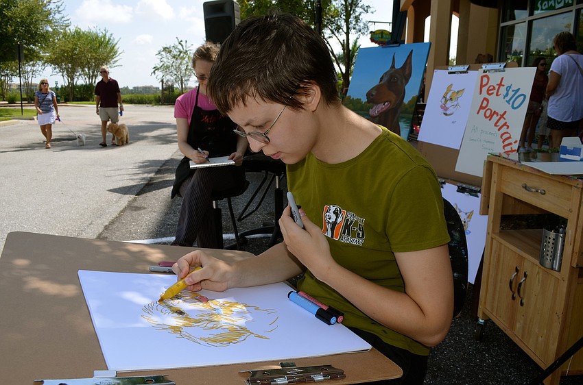 Asia Akhmetova sketches a drawing of a dog.