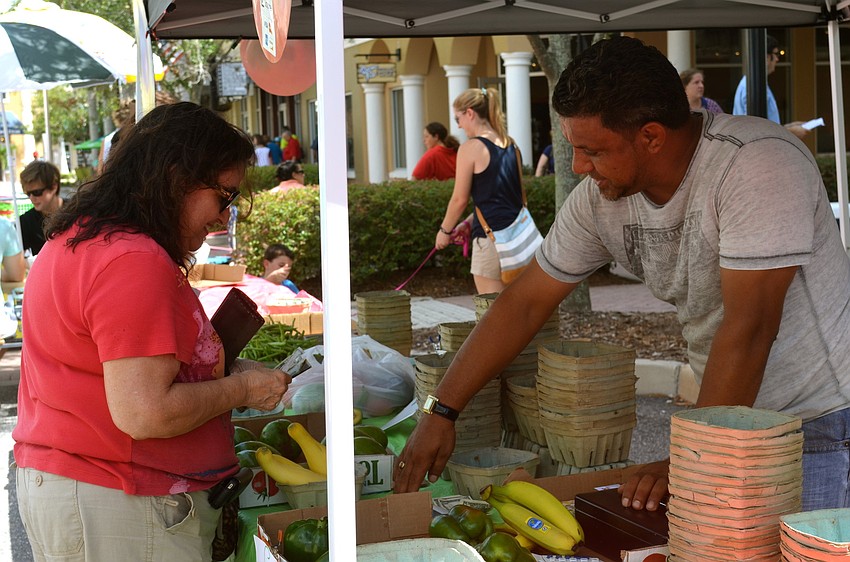Kathleen Brady decides which produce to purchase.