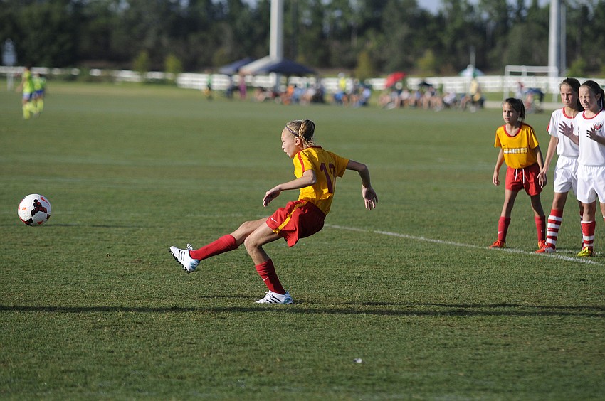 Ten-year-old Nicole Sakre scores on a penalty kick for the U11 Tampa Chargers.