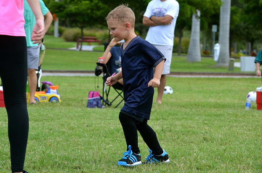 Connor Tredford, of the Gold Fish team, braces for a kick.