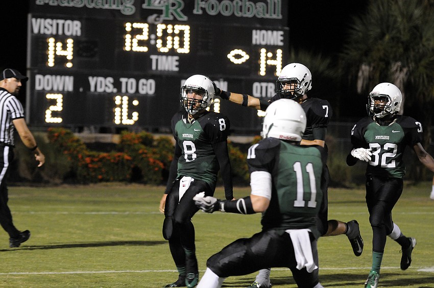 Lakewood Ranch quarterback Chad Rex celebrates following his 10-yard touchdown run in overtime.