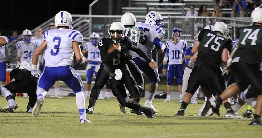 Lakewood Ranch senior quarterback Chad Rex scrambles for a short gain.