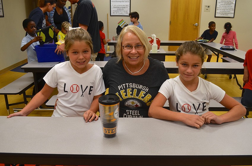 Geri Stobel sits flanked by her granddaughters, Danielle and Ryann Voegel.
