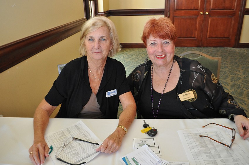 Sandee Davis, of Grimefighters, and Janet Arena, of the Van Wezel, register guests.