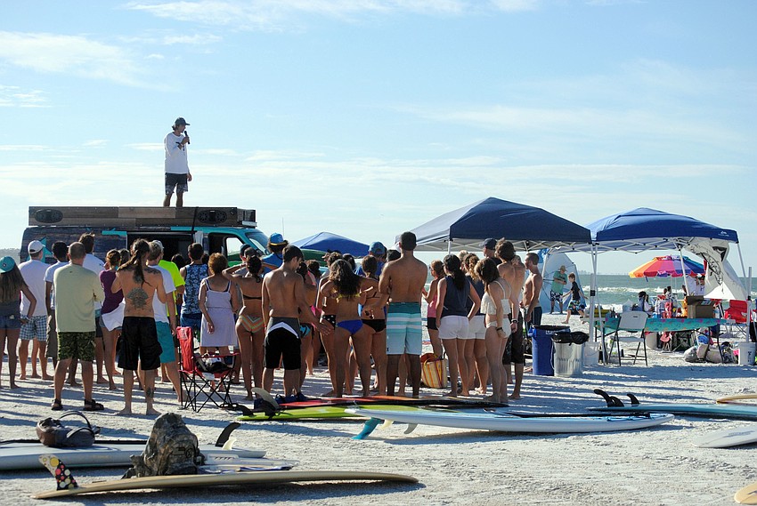 Volunteers gather for a meeting before the 5th annual Hang Ten for Autism surfing event begins.