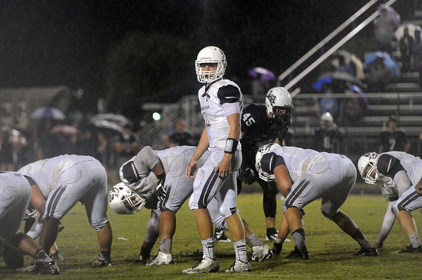 Braden River quarterback Jacob Huesman looks back to the sideline for the play.