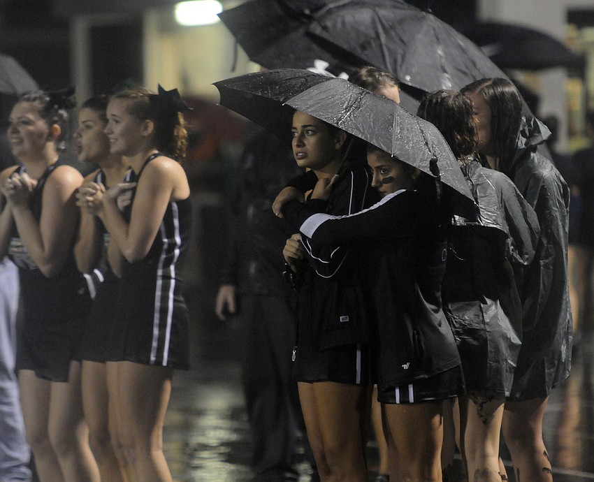 Members of the Lakewood Ranch High cheerleading squad try to stay warm during the second half.