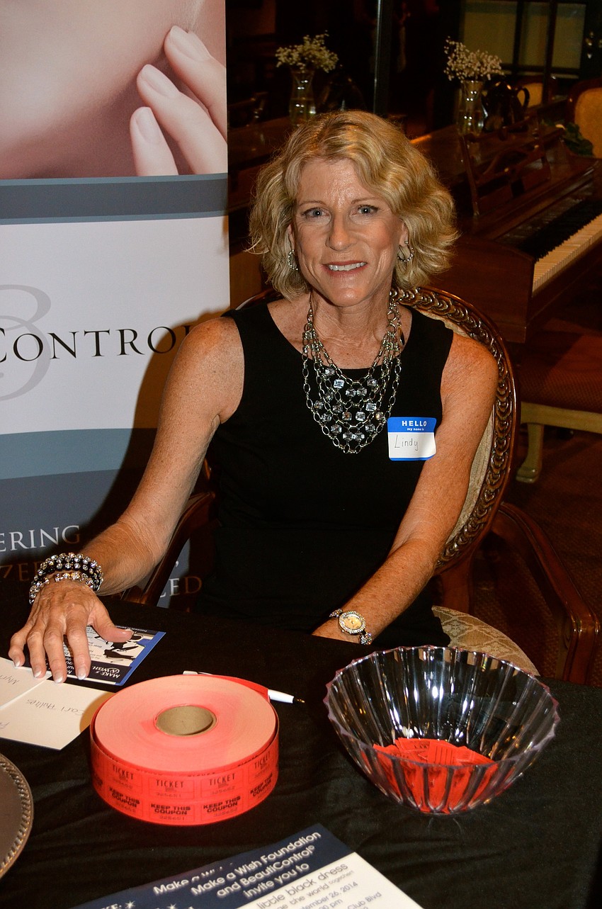 Lindy Foster accepts the $10 admission fee, which benefits the Make-A-Wish Foundation.