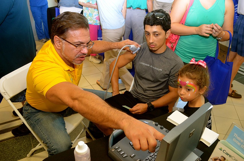 Dr. William Bennett explains an ultrasound to Armando Quiroz.