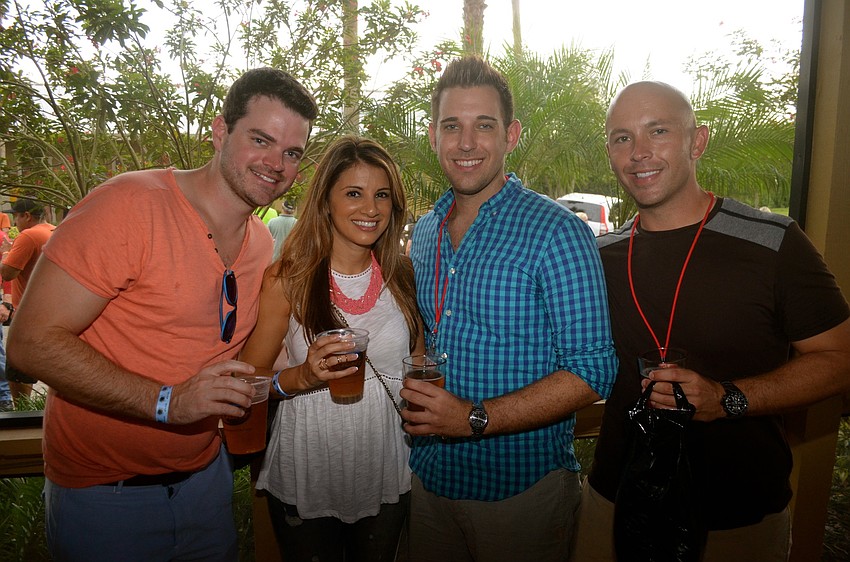 Shea and Kate Tully hide from the rain with Andrew Warfield and Michael Brandon.