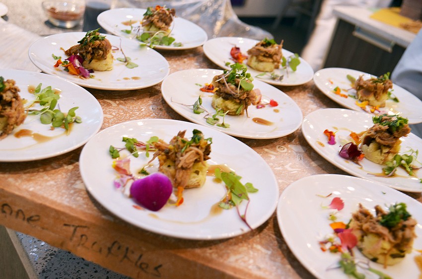 Braised lamb on bread pudding with brandy sauce and cilantro