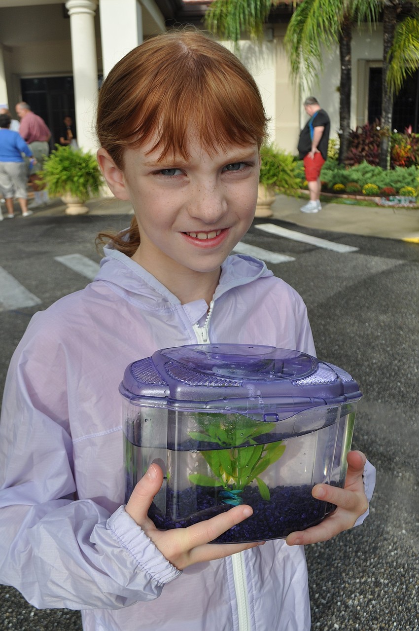 Abby Cummings, a third-grader at McNeal Elementary, brings her fish, Moko Blue.