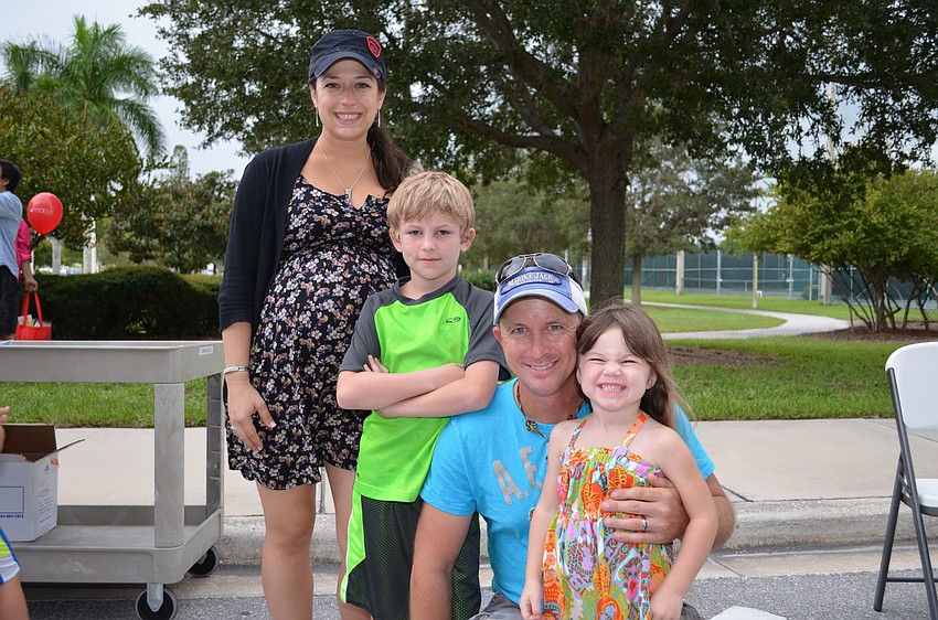 Sarah Anderson, Braden Lamb, Luke Lamb and his daughter Kensley Lamb attend the National Night Out Against Crime on Tuesday night.