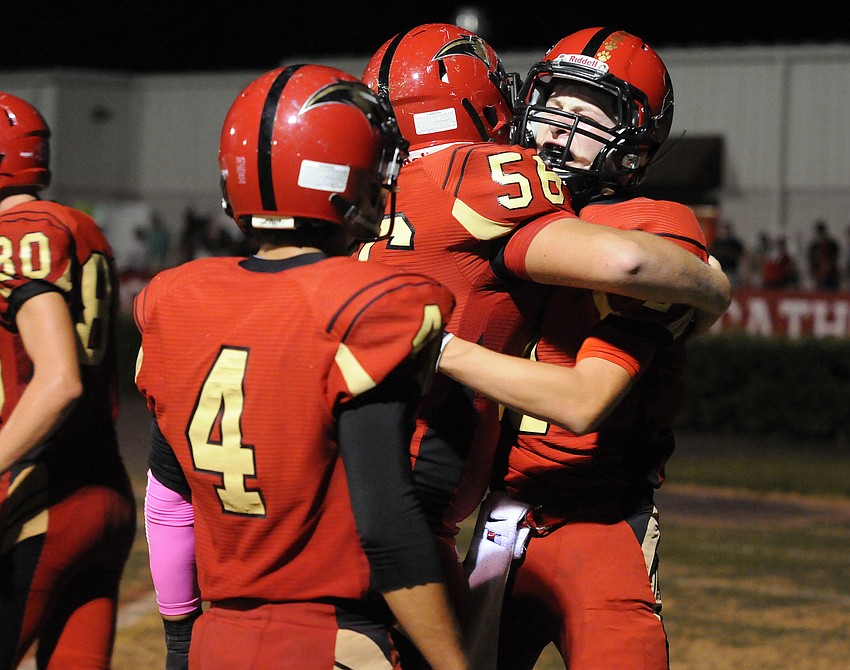 Offensive lineman Eric Orsini congratulates wide receiver Tristan Hillerich following Hillerichâ€™s 22-yard touchdown catch in the fourth quarter.