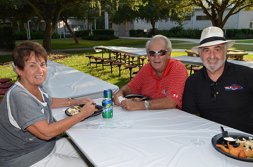 Angie and Tony Tambini sit with Howard Katz at the Cardinal Mooney Fish Fry.
