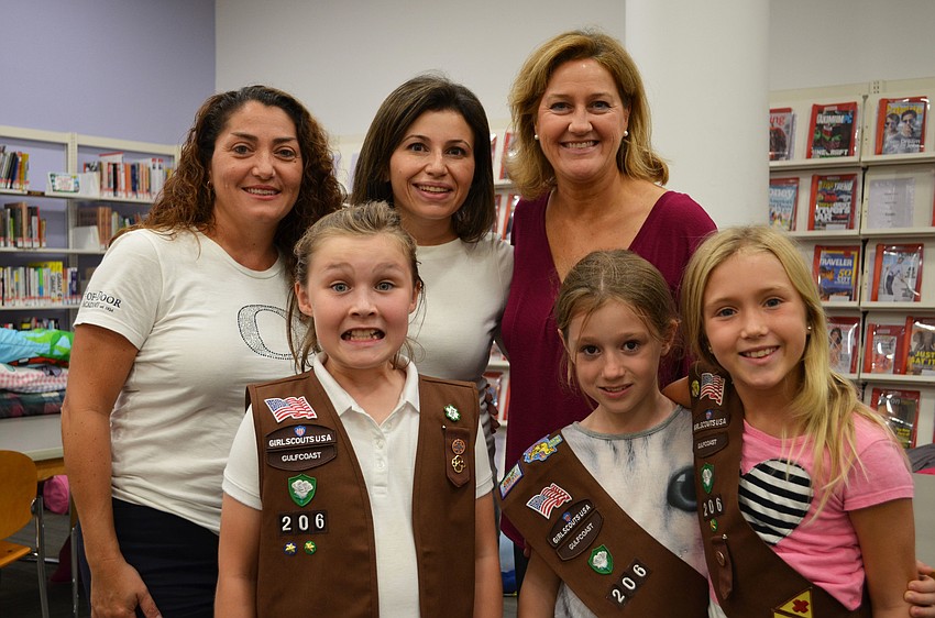 Monica Baldwin, Idil Greenberg, Karen Constant and troupe members Rachel, Elizabeth and Keirra from Troupe 206 attend the Scout About the Library event Friday evening.