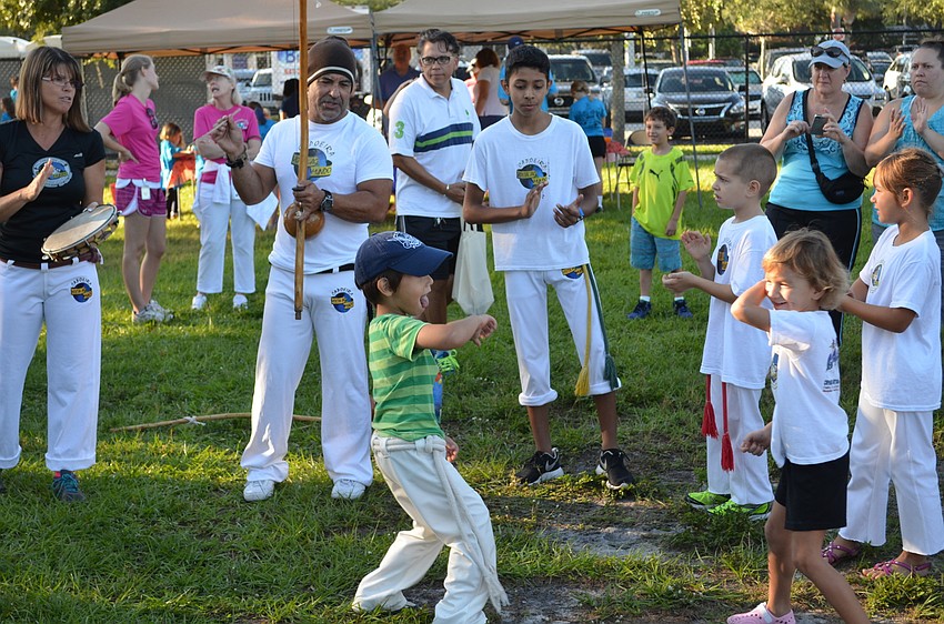 Members of Capo Kids practice the Brazilian martial art of Capoeira during  a â€œrodaâ€ or play Capoeira at the Phillippi Shores 7K Run.