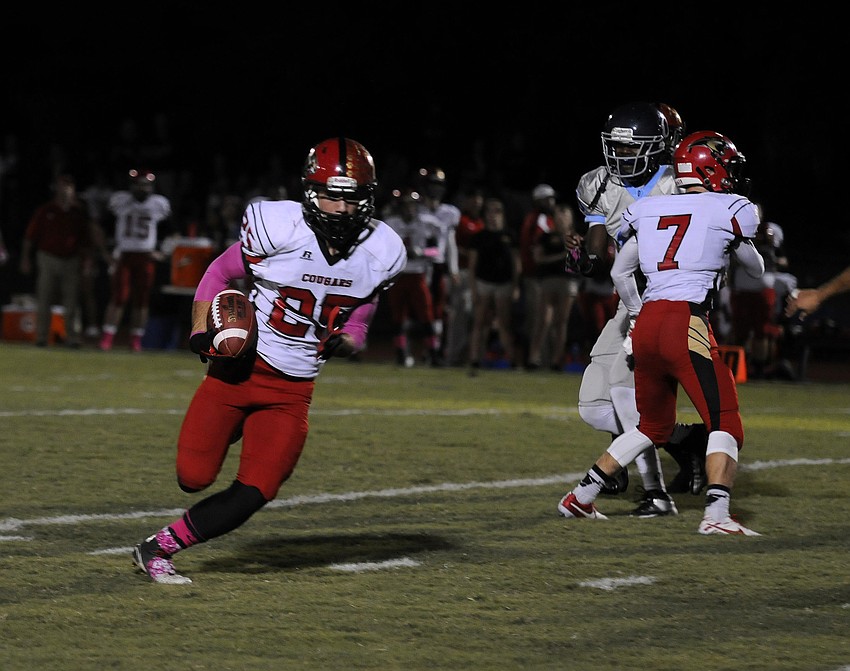 Cardinal Mooney safety Vinny Conetta returns a punt for the Cougars.
