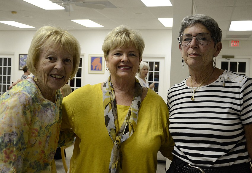 Jean White, left, came to the meeting with her neighbor, Jamie Engel, middle, a new member. President Madelyn Spoll, right, chatted with Engel about Oklahoma- both of them used to live there.