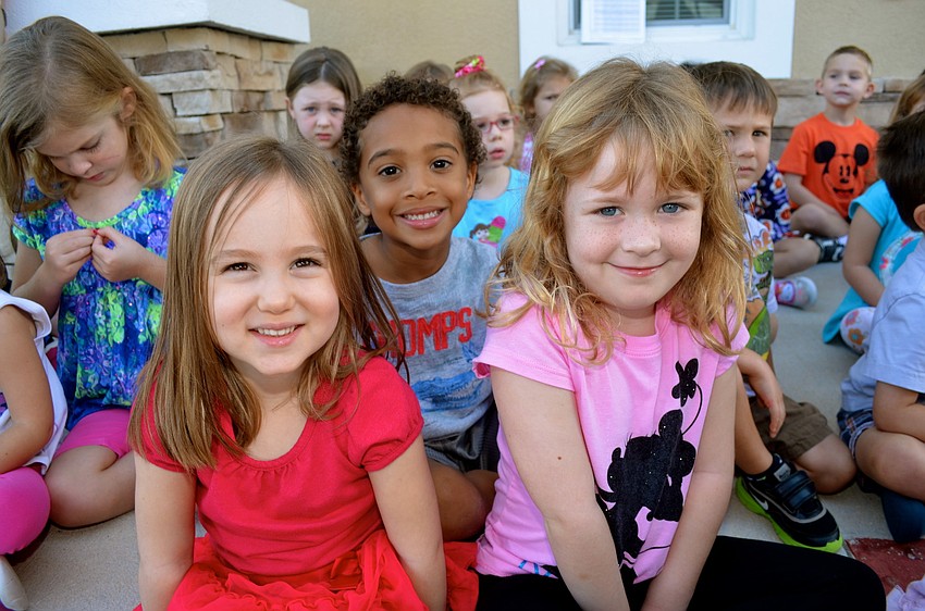 Noelle Stead, Devin Raines and Ella Tuthill wait for their chance to sit in a race car.