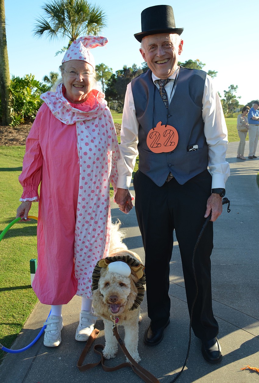 Mary Lou Allison dressed as a clown and her husband Ted is the lion tamer for their â€œlionâ€ Millie