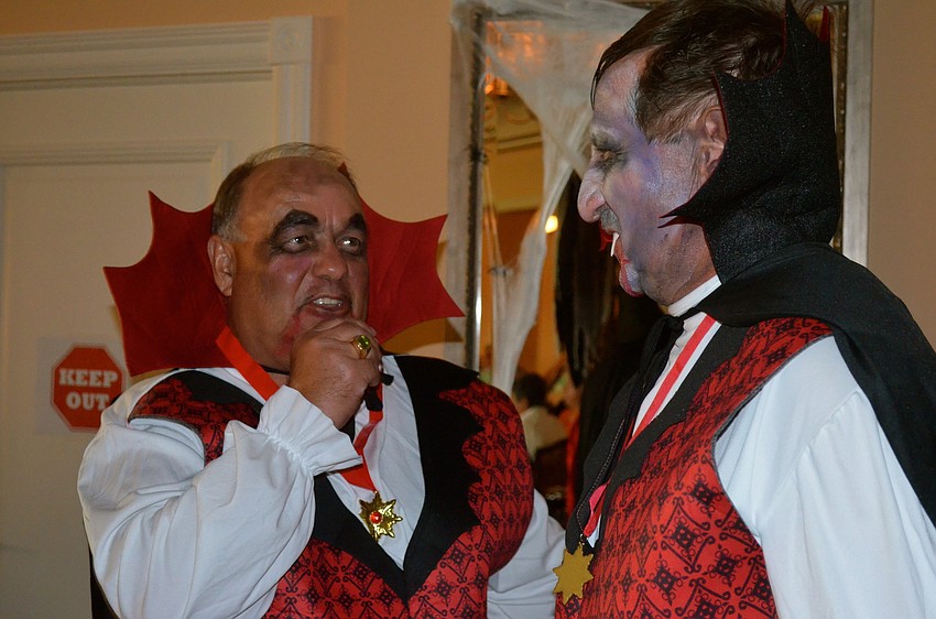Jeff Blevins and David Fontaine get their Dracula costumes ready.