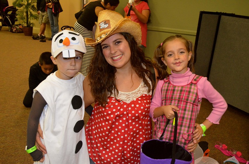 Melissa Rubenstein kneels, flanked by her son, Aiden, and daughter, Julia.
