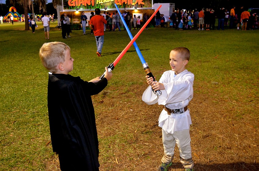 Adriano Tulino and Devin Allan engage in a light saber battle.