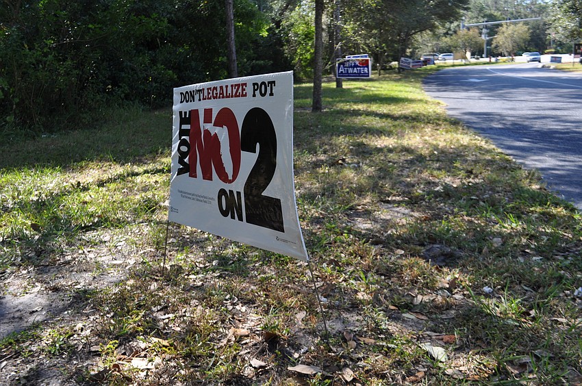 Campaign signs for candidates and amendments alike are posted outside polling stations, including Woodland The Community Church.
