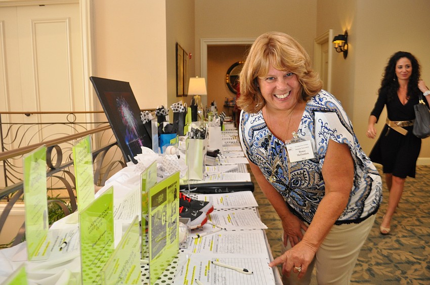 Renee McFadden, of Rosedale, makes her final round at the silent auction.