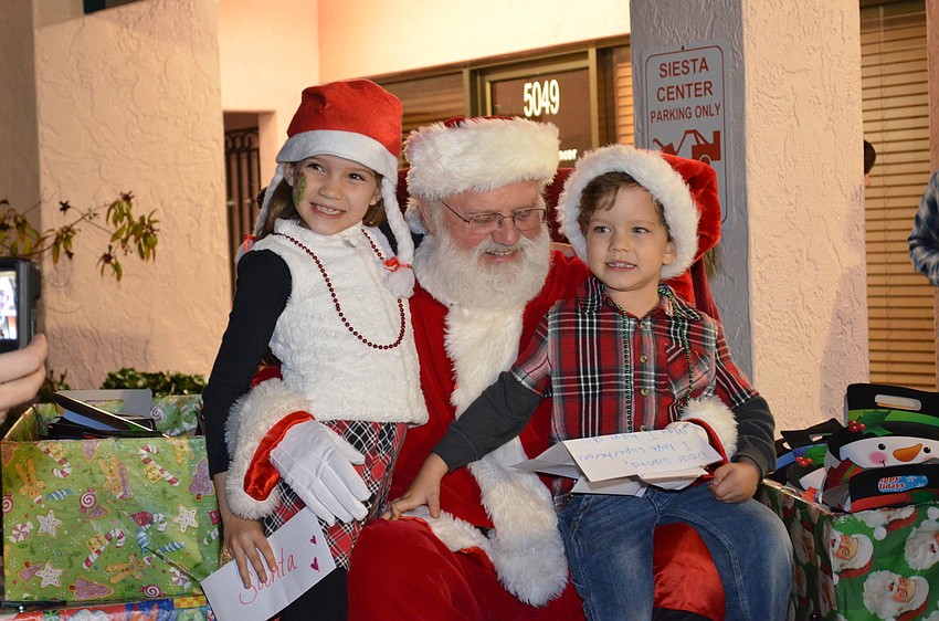 Jadynn Bachman and her brother Jonathan tell Santa Claus what they want for Christmas.