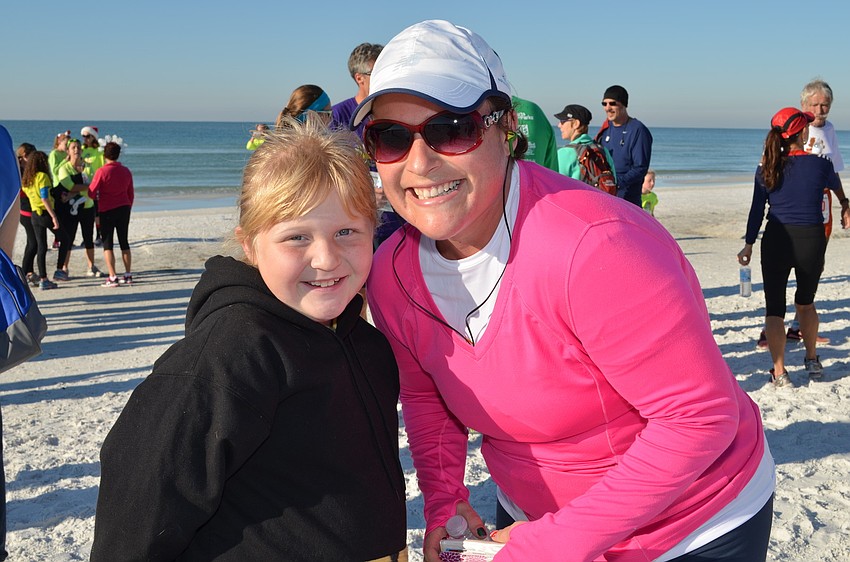 Amanda Burrow with her daughter Lili after the Sandy Claws Beach Run.