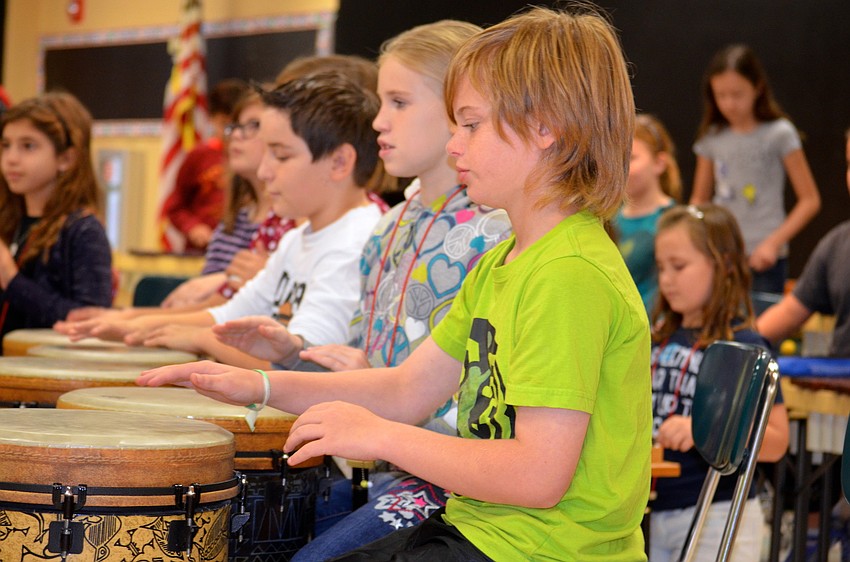 Aiden Hebert plays his drum.