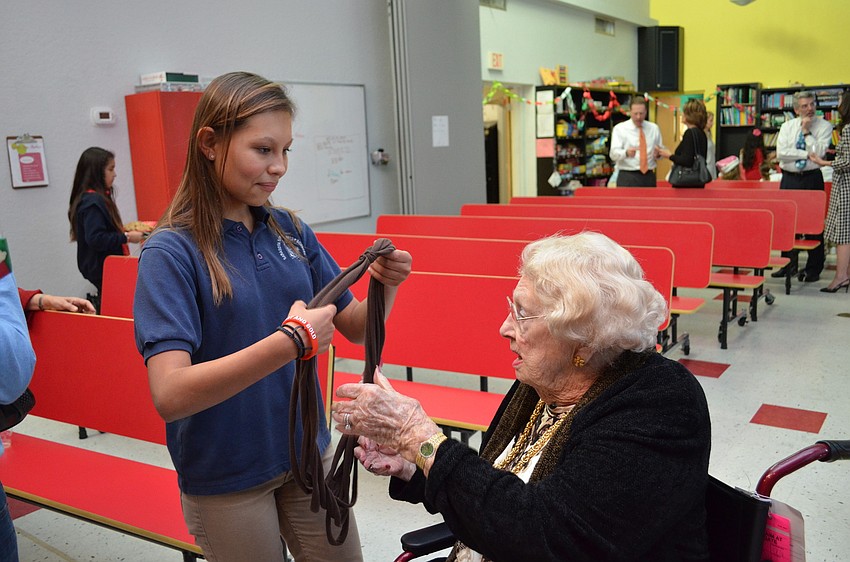 Isabelle Crotsley gives Donna Ogilvie a handmade scarf as a gift.