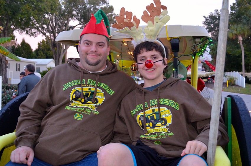 Adam and Jacob Kellenberger hitch a hide on the cart turned tractor.