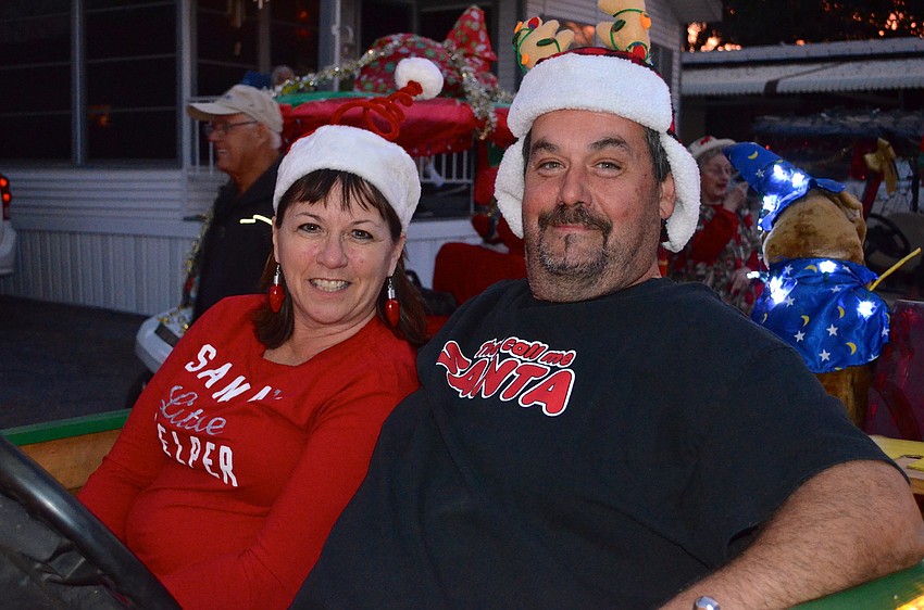 Chris Wirth and Robert Donnely cozy up in their golf cart.