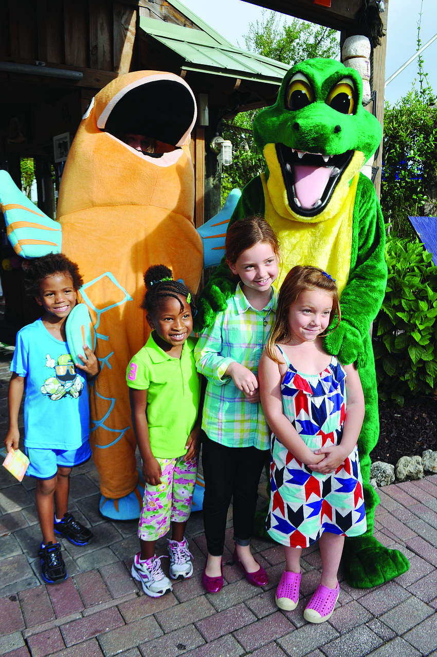 Emma Watson, Zachariah Kersey and Isabella and Lola Scott, of Gullett Elementary, can't resist a photo with Chompy during the Spirit Night mini-golf fundraiser.