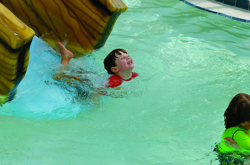 Lucas Flynn plays around in the pool during University Place's Back to School pizza party and supply drive.