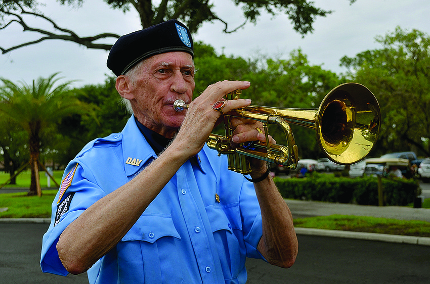 Tom Martin, performs as part of a Flag Day ceremony at the Palm-Aire Country Club. Martin, of Disabled American Veterans, has played the same trumpet since he was 15.