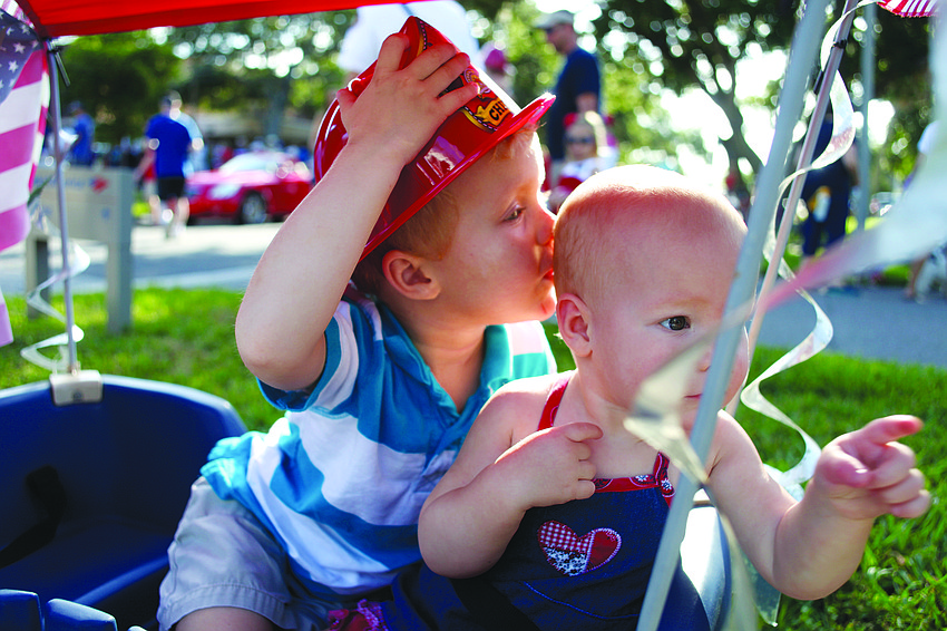 Colin Bankert, 3, kisses his sister, Giuliana, 1, during the Longboat Key Fourth of July Freedom Fest held July 4, on Bay Isles Road and in Bicentennial Park.