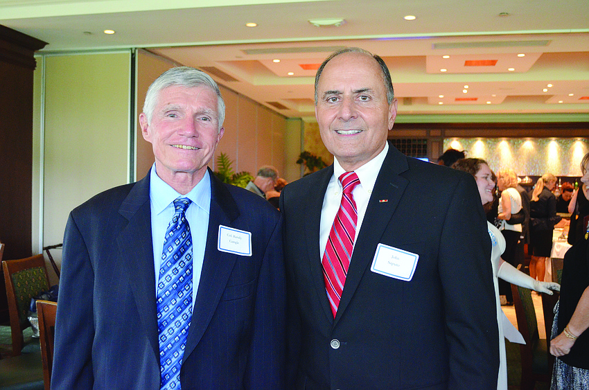 Guest speaker Col. Randy Gangle congratulates honoree Col. John Saputo for receiving the National Society of the Daughters of the American Revolution's Sara DeSoto Chapterâ€™s Seven Seals Award and Medal of Honor May 1.