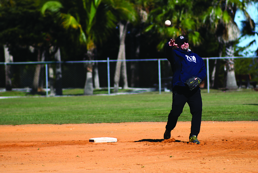 Second baseman Barry Rookes throws the ball to second base during the Longbeach Village Association's softball game Jan. 18, at Bayfront Park Recreation Center.