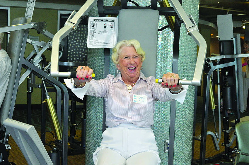 Alida de Jongh tries out some of the new equipment at the ribbon-cutting ceremony for Plymouth Harbor's Wellness Center.