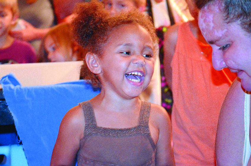Sa'nora Goodwin gets splashed by a lobster with her mom, Patricia Lacy, at Selby Public Library. Children learned about marine life from Florida Aquarium representatives.