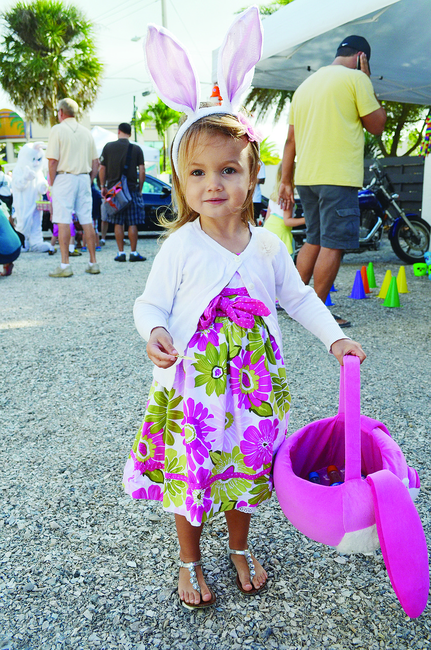 Jessie Ochsendorf collects eggs at Siesta Key Village's annual Easter Party.