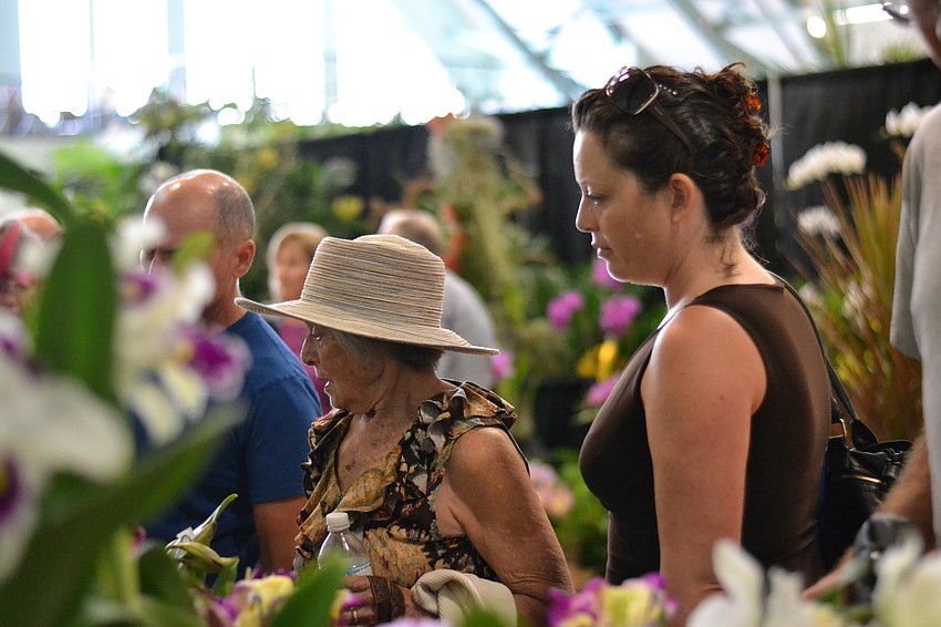 Constance Ellison and Nakca Bagn-Ellison browse orchids that were available to purchase at the Orchid Show.