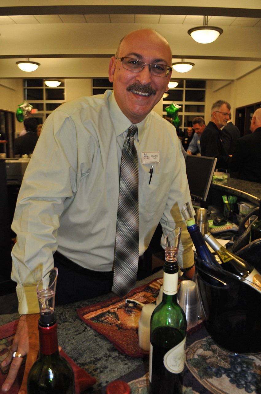 Charles Visali, of Time for Wine, pours wine for guests.