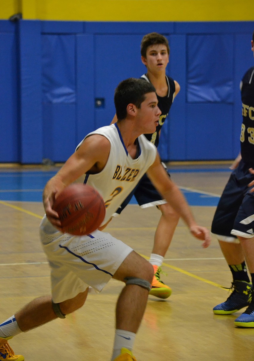 Junior Brandon Bontrager tries to dribble past defenders.