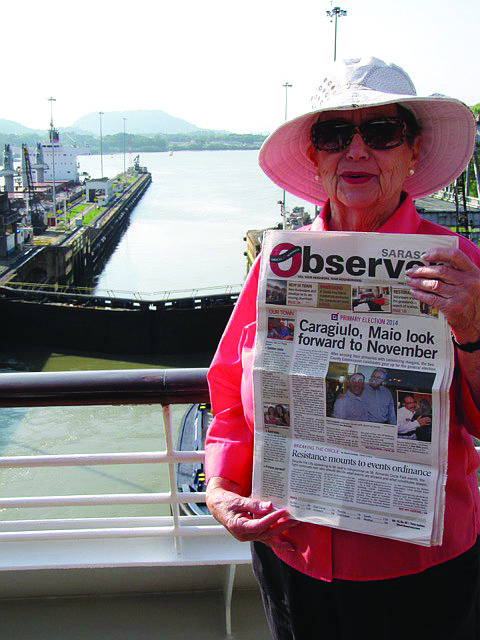 PAPER TRAIL. Shirley Fein brought her Sarasota Observer along on a family cruise that originated in San Francisco and terminated in New York City. Here she is holding the paper at the Panama Canal.