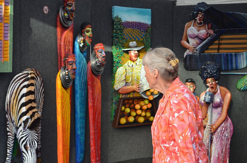 Sharon Firestone browses the artwork.